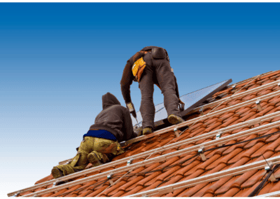 A picture of two men on a roof installing terracotta roofing in Port St. Lucie, FL